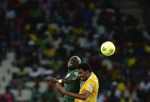 Burkina Faso's Djakaridja Kone (L) jumps for the ball against Ethiopia's Addis Hintsa in Nelspruit on January 25, 2013